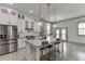 Bright and airy kitchen featuring white cabinetry, an island with seating, and modern appliances at 4208 Sierra Creek Ct, Hoschton, GA 30548