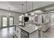 Kitchen with a large island overlooking the living room featuring a fireplace at 4208 Sierra Creek Ct, Hoschton, GA 30548