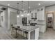 Modern kitchen with white cabinetry, stainless steel appliances, and an island with pendant lights at 4208 Sierra Creek Ct, Hoschton, GA 30548