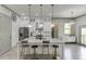 Charming kitchen with a large island, pendant lighting, and white cabinets at 4208 Sierra Creek Ct, Hoschton, GA 30548