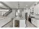 Bright kitchen featuring a central island, stainless steel appliances, and staircase view at 4208 Sierra Creek Ct, Hoschton, GA 30548