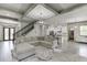 A living room opens to the kitchen and features a staircase with wrought iron spindles at 4208 Sierra Creek Ct, Hoschton, GA 30548