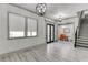 Spacious living room with hardwood flooring and a view into the formal dining area at 4208 Sierra Creek Ct, Hoschton, GA 30548