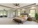 Spacious main bedroom with seating area, tray ceilings, two windows and ensuite access at 4208 Sierra Creek Ct, Hoschton, GA 30548