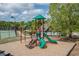 Community playground showcasing green slides, climbing apparatuses, and mature landscaping at 4208 Sierra Creek Ct, Hoschton, GA 30548