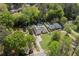 Expansive property featuring a beautiful home, lush green lawn, mature trees, and an inviting in-ground pool at 5641 Roberts Dr, Dunwoody, GA 30338