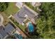 Aerial shot of home and grounds showcasing landscaping and an inground swimming pool at 5641 Roberts Dr, Dunwoody, GA 30338