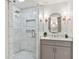 Modern bathroom with marble tile, glass shower, and stylish vanity at 5641 Roberts Dr, Dunwoody, GA 30338