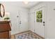 Entryway with hardwood floors, geometric rug, and front door with sidelights at 5641 Roberts Dr, Dunwoody, GA 30338