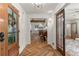 Spacious foyer with herringbone wood floors, white walls, and views to the dining and living areas at 5641 Roberts Dr, Dunwoody, GA 30338