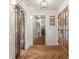 Elegant foyer showcasing beautiful herringbone wood floors, white wainscoting, and wood trim at 5641 Roberts Dr, Dunwoody, GA 30338