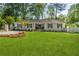 Charming, freshly painted one-story home with a large green lawn and dark blue shutters at 5641 Roberts Dr, Dunwoody, GA 30338