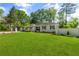 Beautifully landscaped front yard featuring lush green lawn and ranch style home at 5641 Roberts Dr, Dunwoody, GA 30338