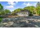 Exterior shot of attached three car garage with driveway and backyard access at 5641 Roberts Dr, Dunwoody, GA 30338
