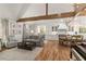 Bright and open-concept living space with an adjoining kitchen and high ceilings with wood beams at 5641 Roberts Dr, Dunwoody, GA 30338