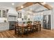 Gourmet kitchen featuring modern appliances, marble countertops, and a spacious dining area at 5641 Roberts Dr, Dunwoody, GA 30338