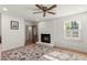 Bright living room featuring a brick fireplace, wood floors, and natural light from the window at 5641 Roberts Dr, Dunwoody, GA 30338