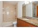 Well-lit bathroom featuring a granite vanity top, neutral tile, and bathtub at 1253 Caroline Ne St # 229, Atlanta, GA 30307