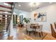 Open-concept dining and living room with modern lighting, hardwood floors, and staircase at 1253 Caroline Ne St # 229, Atlanta, GA 30307