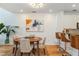 Bright dining room featuring hardwood floors, stylish light fixture and breakfast bar, with access to the kitchen at 1253 Caroline Ne St # 229, Atlanta, GA 30307
