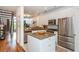Bright kitchen features stainless steel appliances, white cabinets, granite countertops, and a stylish island at 1253 Caroline Ne St # 229, Atlanta, GA 30307