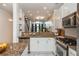 Open kitchen with stainless appliances, granite counters, and view to living spaces and staircase at 1253 Caroline Ne St # 229, Atlanta, GA 30307