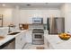Modern kitchen boasts stainless steel appliances, white cabinetry, and marble countertops at 1253 Caroline Ne St # 229, Atlanta, GA 30307