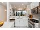 Open kitchen with stainless appliances, marble counters, and view to living spaces and staircase at 1253 Caroline Ne St # 229, Atlanta, GA 30307