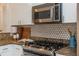 Close up on a kitchen with white and stainless steel appliances and granite countertops at 1253 Caroline Ne St # 229, Atlanta, GA 30307