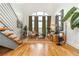 Bright living room with hardwood floors, exposed staircase, and arched windows providing lots of natural light at 1253 Caroline Ne St # 229, Atlanta, GA 30307