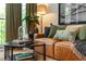 Cozy living room with leather sofa, eclectic decor, and view of the balcony at 1253 Caroline Ne St # 229, Atlanta, GA 30307