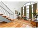 Bright living room with hardwood floors, exposed staircase, and large arched windows that let in natural light at 1253 Caroline Ne St # 229, Atlanta, GA 30307