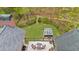 Aerial view of fenced backyard with hot tub, outdoor seating, patio and manicured lawn surrounded by lush trees at 1410 Daley Ridge Ct, Lawrenceville, GA 30045