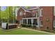 A beautiful brick home featuring a charming backyard with a well-maintained lawn and a relaxing hot tub at 1410 Daley Ridge Ct, Lawrenceville, GA 30045