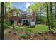 A beautiful brick home featuring a charming backyard with a well-maintained lawn and a relaxing hot tub at 1410 Daley Ridge Ct, Lawrenceville, GA 30045