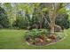 Spacious backyard featuring a well-manicured lawn and mature trees at 1410 Daley Ridge Ct, Lawrenceville, GA 30045