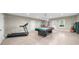Expansive basement showcasing a billiard table, gym equipment, recessed lighting, and potential for versatile use at 1410 Daley Ridge Ct, Lawrenceville, GA 30045