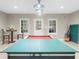 Large basement featuring a billiard table, ping pong table, and wet bar area, perfect for entertaining and recreation at 1410 Daley Ridge Ct, Lawrenceville, GA 30045