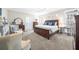 Well-lit bedroom with a dark wood bed frame and neutral decor, offering a serene and inviting atmosphere at 1410 Daley Ridge Ct, Lawrenceville, GA 30045