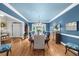 Formal dining room with blue accent wall, chandelier, and hardwood floors at 1410 Daley Ridge Ct, Lawrenceville, GA 30045