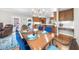 Traditional dining room with wood table, blue chairs, and chandelier lighting, blending classic design with modern accents at 1410 Daley Ridge Ct, Lawrenceville, GA 30045