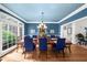 Elegant dining room featuring a chandelier, blue walls, and large window at 1410 Daley Ridge Ct, Lawrenceville, GA 30045