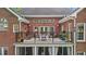 Brick home exterior featuring a second story deck with table and chairs at 1410 Daley Ridge Ct, Lawrenceville, GA 30045