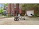 Brick home's exterior featuring a patio with fire pit, fenced yard and an attached garage at 1410 Daley Ridge Ct, Lawrenceville, GA 30045