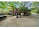 Brick home's rear exterior featuring a patio with fire pit, fenced yard, hot tub, and driveway at 1410 Daley Ridge Ct, Lawrenceville, GA 30045