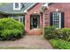 All-brick home featuring a covered front entrance with lovely landscaping at 1410 Daley Ridge Ct, Lawrenceville, GA 30045