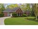 Traditional brick home with lush green lawn, mature trees, and a winding driveway at 1410 Daley Ridge Ct, Lawrenceville, GA 30045