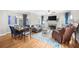 Bright and airy living room and dining area with hardwood floors, blue accents, and a cozy fireplace at 1410 Daley Ridge Ct, Lawrenceville, GA 30045