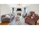 Comfortable living room with a large sofa, fireplace, and natural light creating a cozy and inviting atmosphere at 1410 Daley Ridge Ct, Lawrenceville, GA 30045