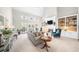 Open-concept living room with fireplace, built-ins, French doors and vaulted ceilings at 1410 Daley Ridge Ct, Lawrenceville, GA 30045